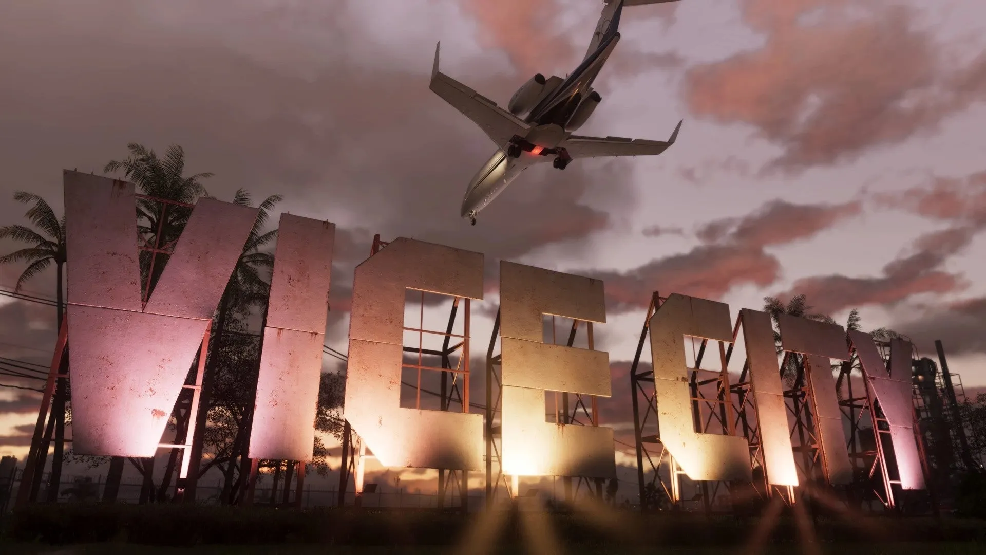 Un avión privado vuela bajo sobre grandes letras iluminadas que forman Vice City, bajo un cielo rosa al atardecer.